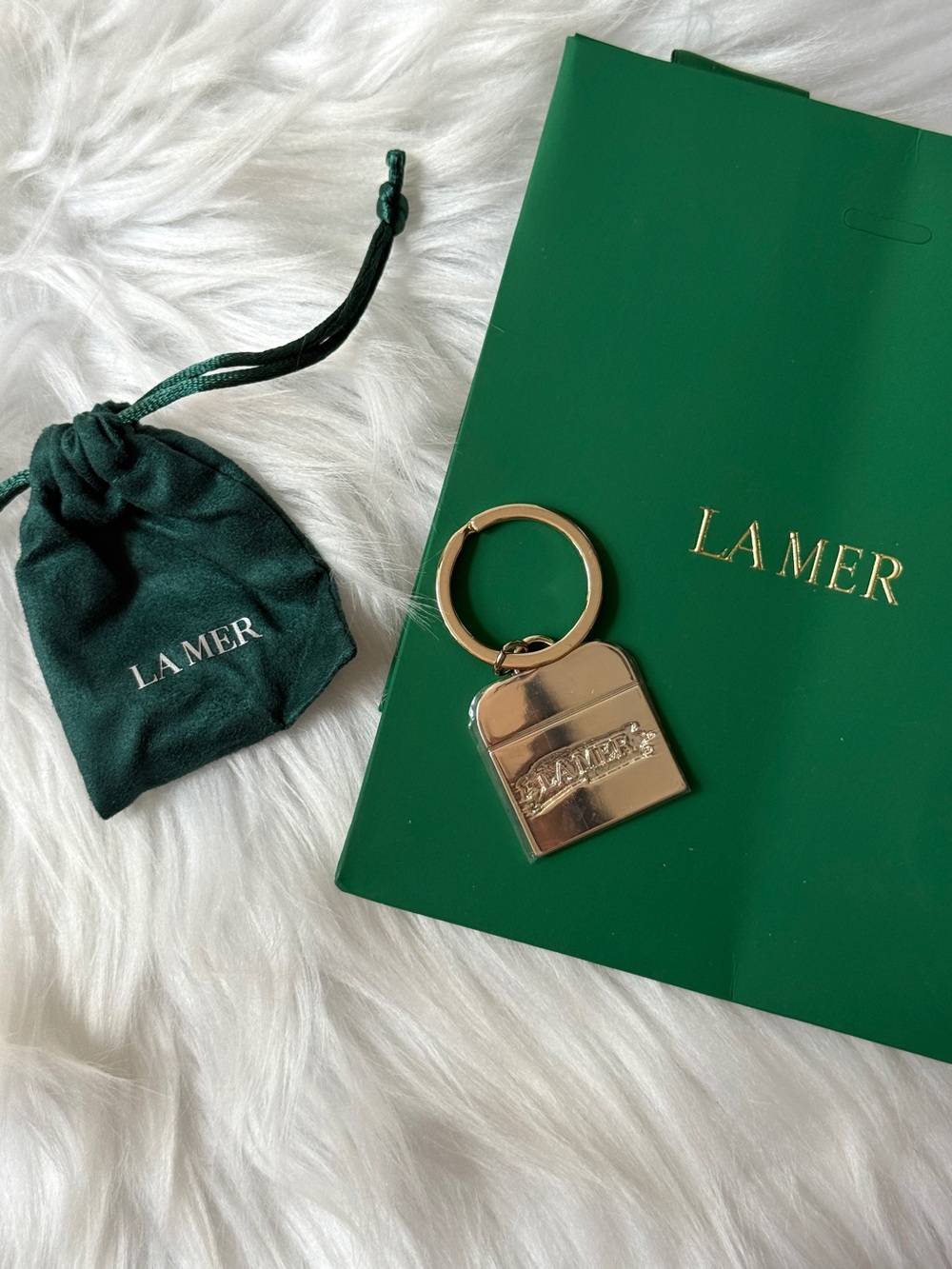 La Mer Gold Padlock Keyring with Green Pouch Sealed in mica
